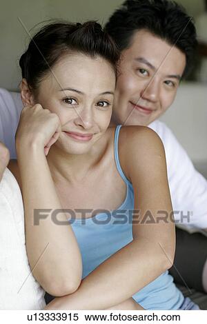 Stock Photography - View of a young couple smiling.. Fotosearch