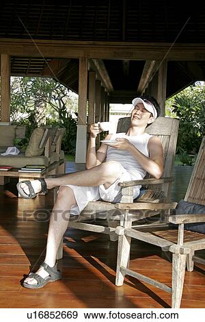 Stock Photo - View of a young man relaxing.. Fotosearch