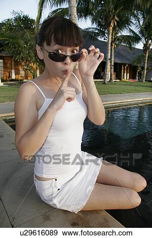 View of a young woman indicating silence. View Large Photo Image Stock Photo - View of a young woman indicating silence.. Fotosearch
