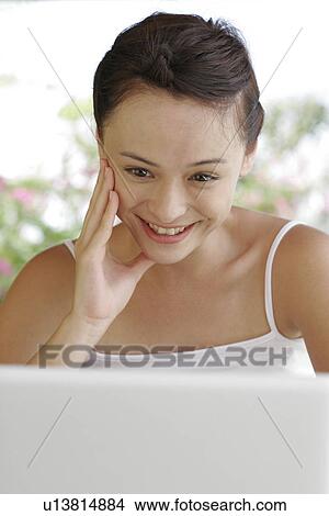 View of a young woman smiling. View Large Photo Image Picture - View of a young woman smiling.. Fotosearch