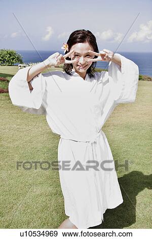 Stock Photo - View of a young woman smiling.. Fotosearch