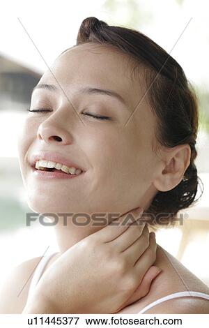 Stock Photo - Young woman smiling.. Fotosearch