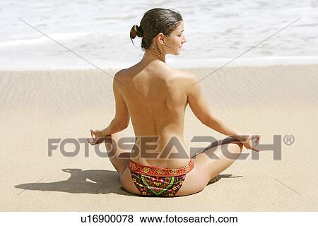 Rear view of a woman exercising on a beach. View Large Photo Image Stock Photo - Rear view of a woman exercising on a beach.. Fotosearch