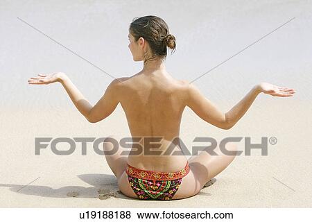 Rear view of a woman exercising on a beach. View Large Photo Image Stock Photo - Rear view of a woman exercising on a beach.. Fotosearch