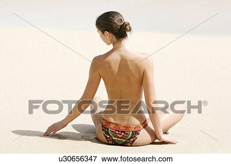 Rear view of a woman exercising on a beach. View Large Photo Image Stock Photo - Rear view of a woman exercising on a beach.. Fotosearch