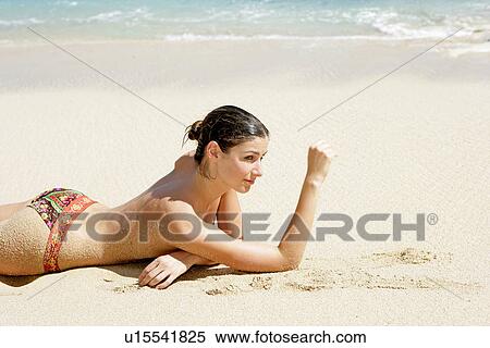 View of a topless woman lying on a beach. View Large Photo Image Stock Photography - View of a topless woman lying on a beach.. Fotosearch