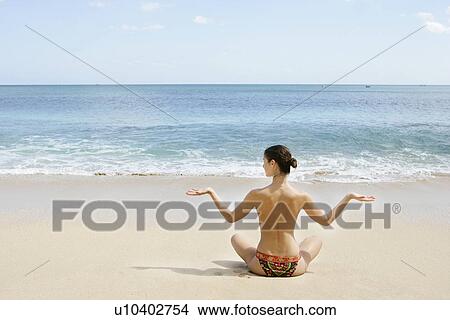View of a woman exercising on a beach. View Large Photo Image Picture - View of a woman exercising on a beach.. Fotosearch
