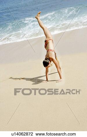 View of a woman performing acrobatic feat. View Large Photo Image Stock Image - View of a woman performing acrobatic feat.. Fotosearch
