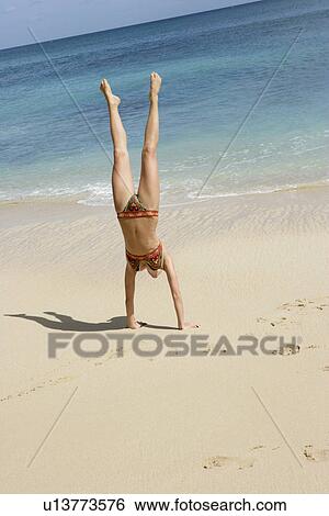 View of a woman performing acrobatic feat. View Large Photo Image Stock Photograph - View of a woman performing acrobatic feat.. Fotosearch