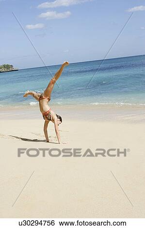 View of a woman performing acrobatic feat. View Large Photo Image Stock Photograph - View of a woman performing acrobatic feat.. Fotosearch