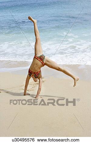 View of a woman performing acrobatic feat. View Large Photo Image Stock Photograph - View of a woman performing acrobatic feat.. Fotosearch