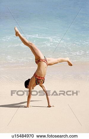 View of a woman upside down on a beach. View Large Photo Image Stock Image - View of a woman upside down on a beach.. Fotosearch