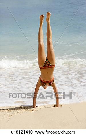View of a woman upside down on a beach. View Large Photo Image Stock Image - View of a woman upside down on a beach.. Fotosearch
