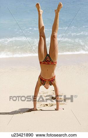 View of a woman upside down on a beach. View Large Photo Image Stock Image - View of a woman upside down on a beach.. Fotosearch