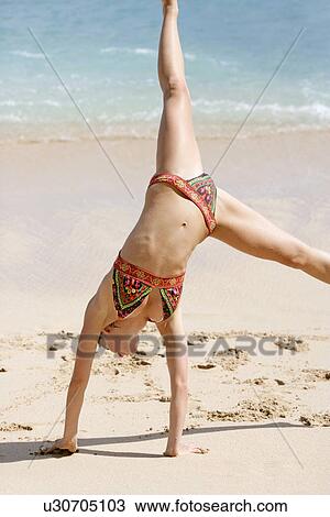 View of a woman upside down on a beach. View Large Photo Image Stock Image - View of a woman upside down on a beach.. Fotosearch