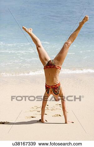 View of a woman upside down on a beach. View Large Photo Image Stock Photo - View of a woman upside down on a beach.. Fotosearch