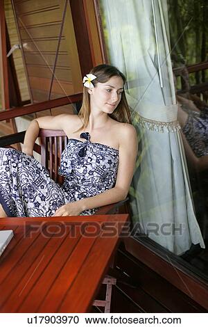A woman sitting in a balcony. View Large Photo Image Stock Image - A woman sitting in a balcony.. Fotosearch