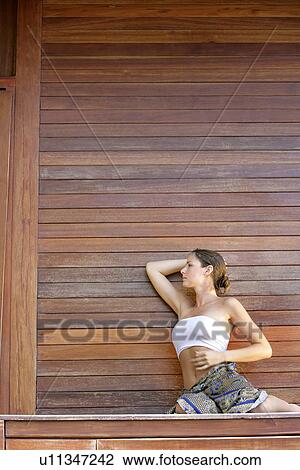 Stock Image - A woman sitting in a pose.. Fotosearch