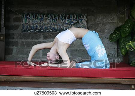 A young woman in yoga posture on red cushion. View Large Photo Image Stock Image - A young woman in yoga posture on red cushion.. Fotosearch