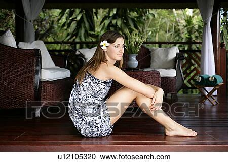 Stock Image - Side view of a beautiful young woman.. Fotosearch