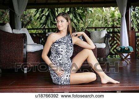 Stock Image - Side view of a beautiful young woman.. Fotosearch