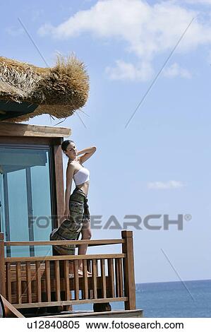Stock Photography - Side view of a beautiful young woman.. Fotosearch