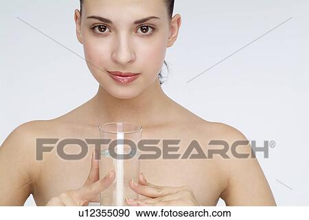 Close-up of a young woman holding glass of water. View Large Photo Image Stock Image - Close-up of a young woman holding glass of water.. Fotosearch