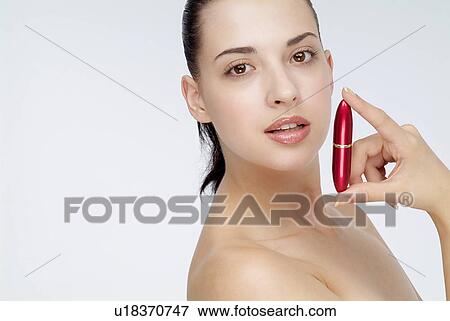 Close-up of a young woman holding lip stick in hand. View Large Photo Image Stock Photo - Close-up of a young woman holding lip stick in hand.. Fotosearch
