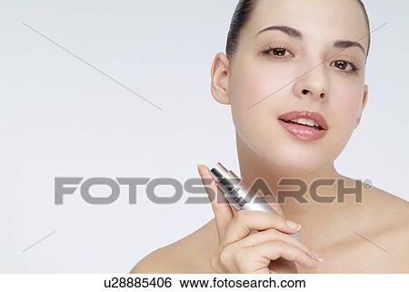 Close-up of a young woman holding lip stick. View Large Photo Image Stock Photograph - Close-up of a young woman holding lip stick.. Fotosearch