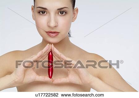 Close-up of a young woman holding lipstick. View Large Photo Image Stock Image - Close-up of a young woman holding lipstick.. Fotosearch