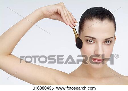 Close-up of a young woman holding makeup brush. View Large Photo Image Stock Photography - Close-up of a young woman holding makeup brush.. Fotosearch