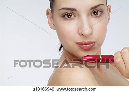 View of a woman holding lipstick. View Large Photo Image Stock Image - View of a woman holding lipstick.. Fotosearch