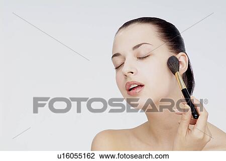 View of a woman using foundation brush. View Large Photo Image Stock Image - View of a woman using foundation brush.. Fotosearch