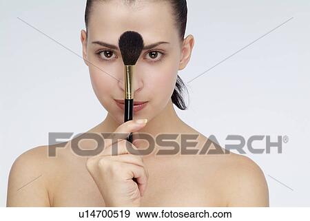 Stock Photo - View of a woman with a brush. Fotosearch