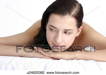 View of a young woman lying, looking away. View Large Photo Image Stock Image - View of a young woman lying, looking away.. Fotosearch