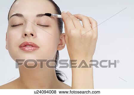View of a young woman using eyebrow pencil. View Large Photo Image Stock Photo - View of a young woman using eyebrow pencil.. Fotosearch