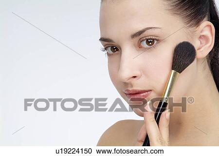 View of a young woman using foundation brush. View Large Photo Image Stock Image - View of a young woman using foundation brush.. Fotosearch