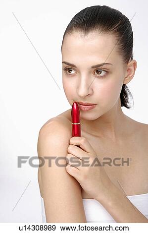 Close-up of a young woman holding lipstick. View Large Photo Image Stock Photo - Close-up of a young woman holding lipstick.. Fotosearch