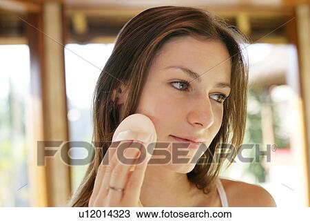 A woman applying makeup. View Large Photo Image Stock Image - A woman applying makeup.. Fotosearch