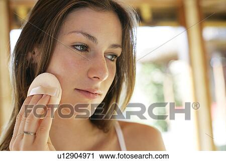 A woman applying makeup. View Large Photo Image Stock Image - A woman applying makeup.. Fotosearch