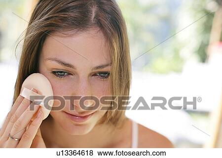Stock Photo - A woman applying makeup.. Fotosearch