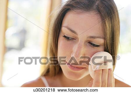 A woman applying makeup. View Large Photo Image Stock Photo - A woman applying makeup.. Fotosearch