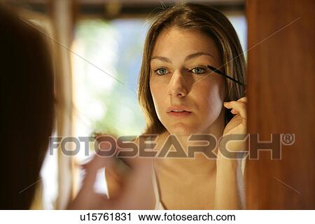 A woman applying mascara. View Large Photo Image Stock Image - A woman applying mascara.. Fotosearch