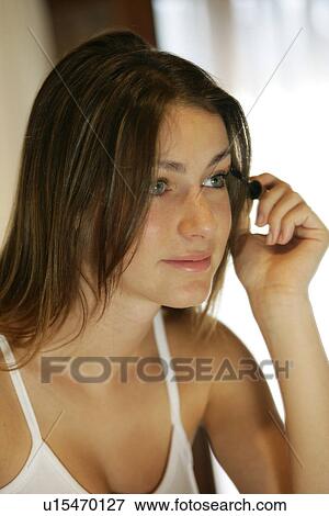 A woman applying mascara. View Large Photo Image Stock Photo - A woman applying mascara.. Fotosearch