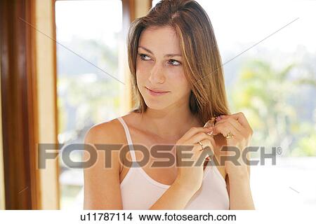 Picture - A woman holding perfume bottle.. Fotosearch