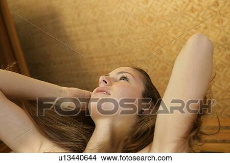 Low angle view of a woman holding her hair. View Large Photo Image Picture - Low angle view of a woman holding her hair.. Fotosearch