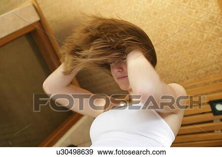 Stock Photo - Low angle view of a young woman.. Fotosearch