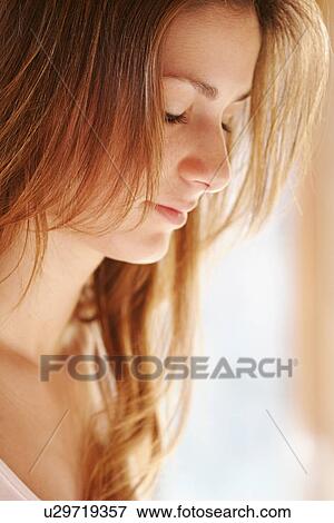 Stock Photo - Side view of a young woman.. Fotosearch