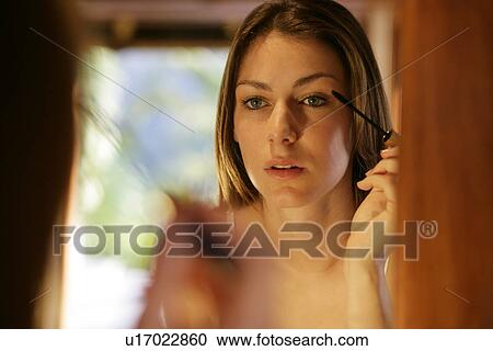 View of a woman applying mascara. View Large Photo Image Stock Image - View of a woman applying mascara.. Fotosearch