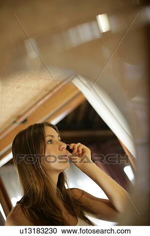 View of a young woman applying mascara. View Large Photo Image Stock Image - View of a young woman applying mascara.. Fotosearch